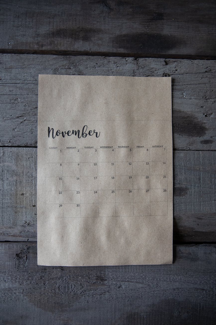 november calendar on gray wooden surface